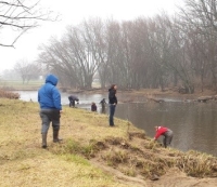 People by river searching for crayfish
